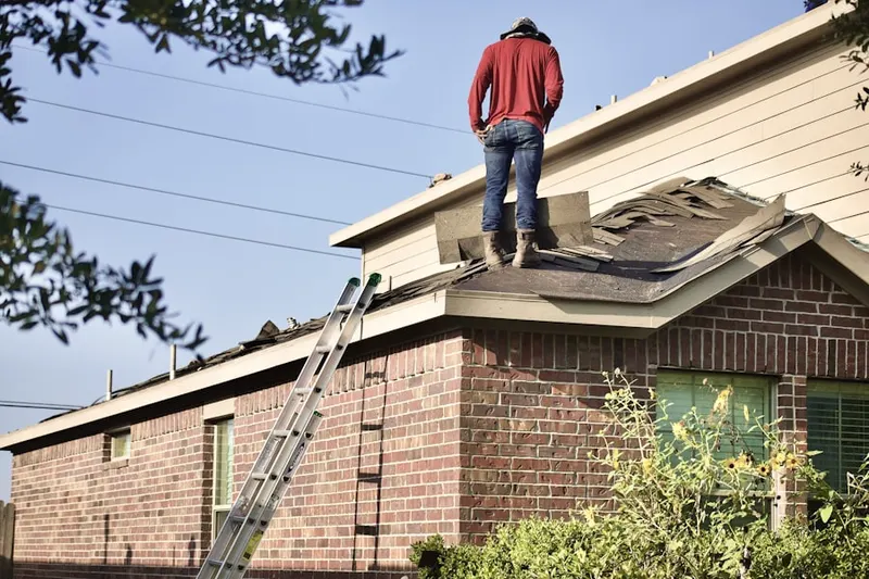 Professional roofer working on a residential roof in Vernon Center